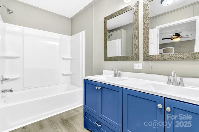 a bathroom with a tub sink and mirror