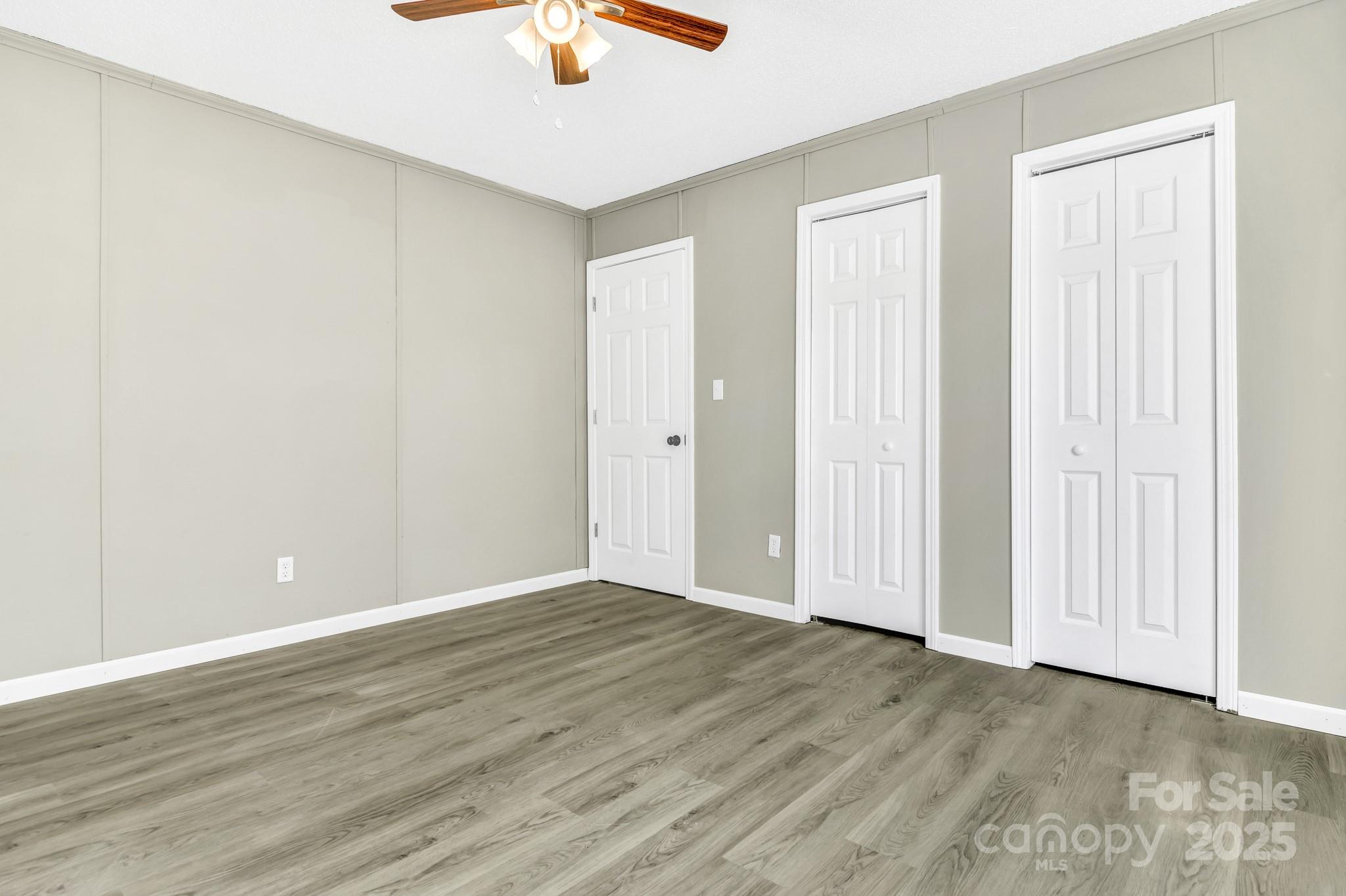 80 Winter Lane, Unit 8&11 Mill Spring, NC 28756 - Photo 34 of 41 an empty room with wooden floor fan and windows