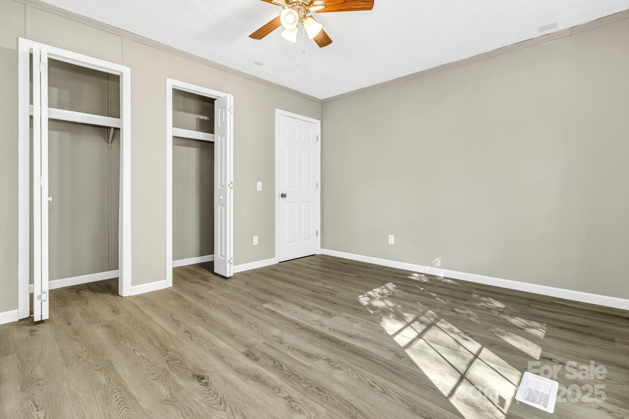 80 Winter Lane, Unit 8&11 Mill Spring, NC 28756 - Photo 36 of 41 an empty room with wooden floor closet and windows