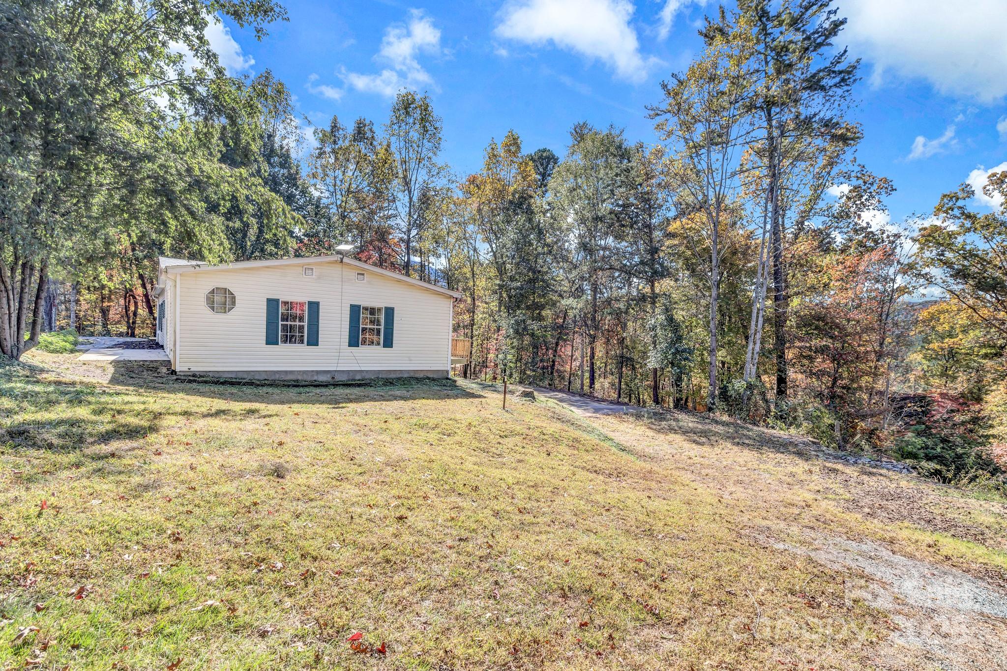 80 Winter Lane, Unit 8&11 Mill Spring, NC 28756 - Photo 7 of 41 a backyard of a house with large trees
