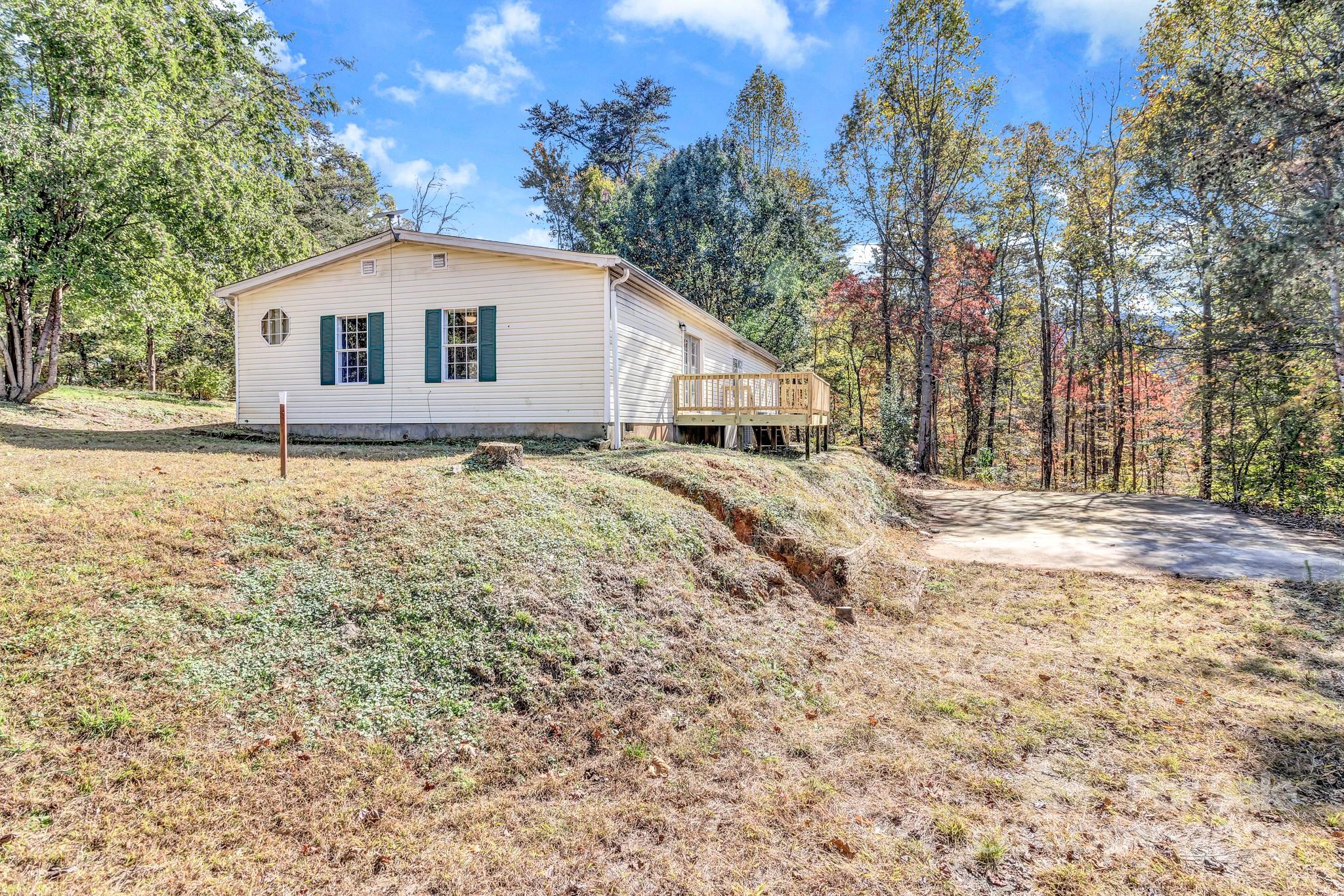 80 Winter Lane, Unit 8&11 Mill Spring, NC 28756 - Photo 8 of 41 a view of a house with a yard