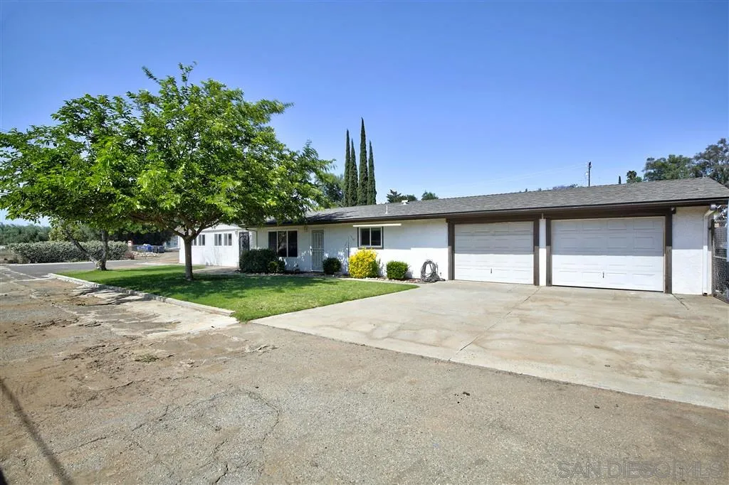 14558 Fruitvale Road Valley Center, CA 92082 - Photo 1 of 24 a view of a house with a yard and large tree