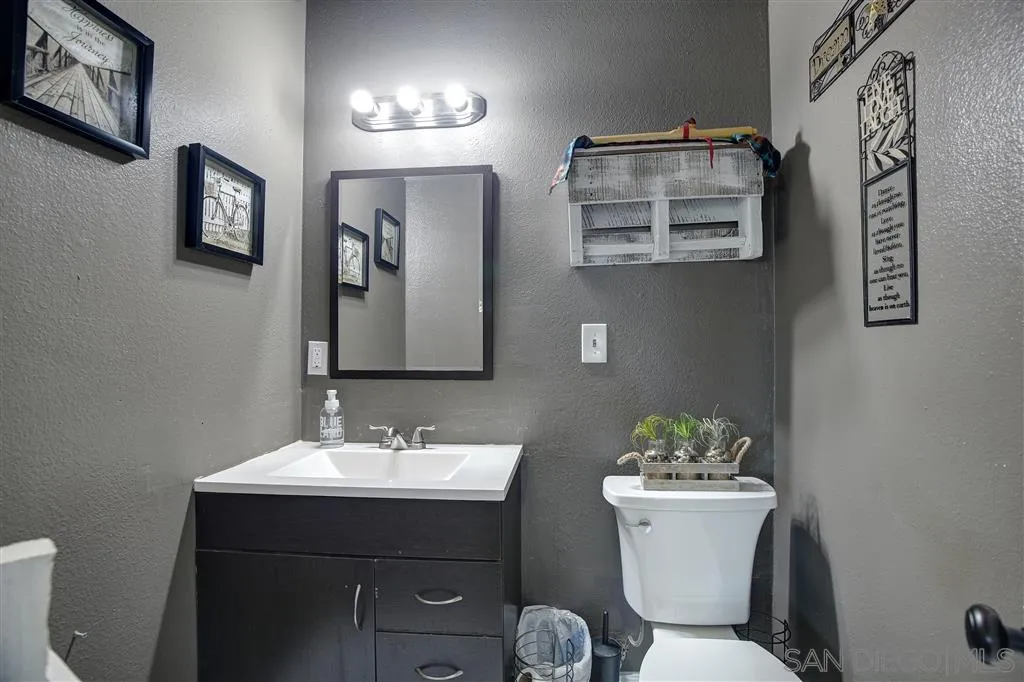 14558 Fruitvale Road Valley Center, CA 92082 - Photo 14 of 24 a bathroom with a toilet sink and mirror
