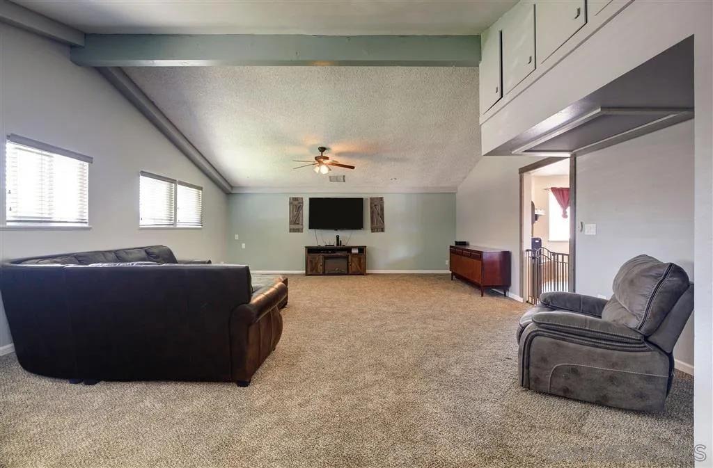 14558 Fruitvale Road Valley Center, CA 92082 - Photo 16 of 24 a living room with furniture and a flat screen tv