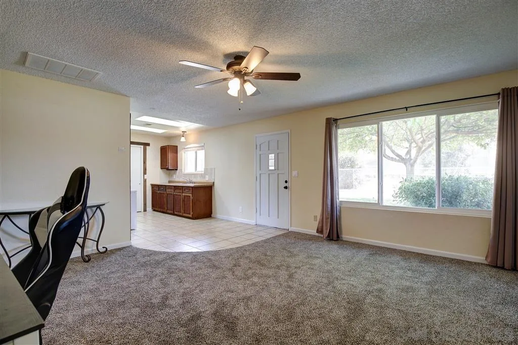 14558 Fruitvale Road Valley Center, CA 92082 - Photo 18 of 24 a view of a livingroom with furniture hardwood floor and a ceiling fan