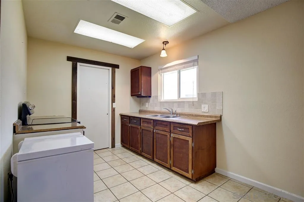 14558 Fruitvale Road Valley Center, CA 92082 - Photo 19 of 24 a kitchen with a stove and a sink