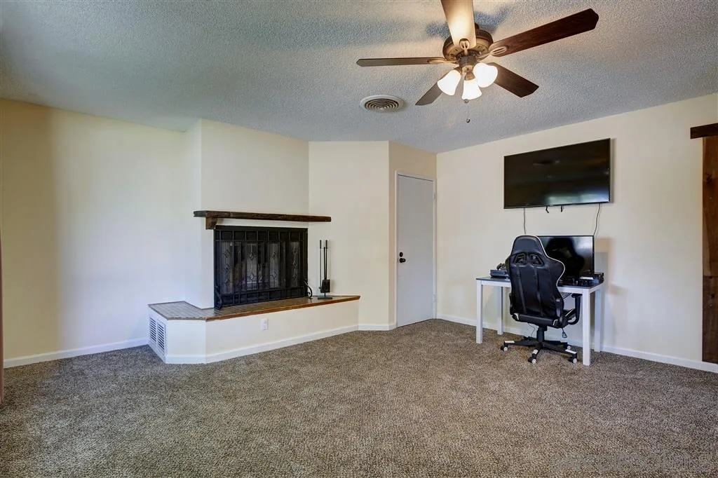 14558 Fruitvale Road Valley Center, CA 92082 - Photo 20 of 24 a living room with furniture and a fireplace