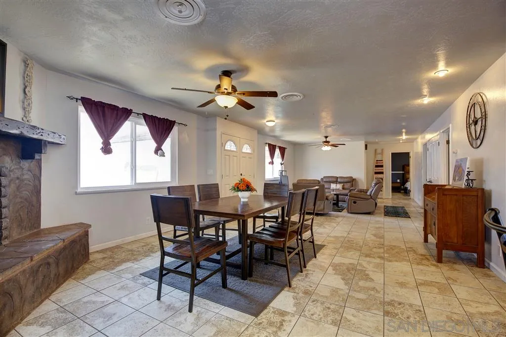 14558 Fruitvale Road Valley Center, CA 92082 - Photo 4 of 24 a view of a dining area with furniture window and wooden floor