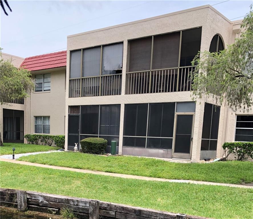 9700 Starkey Road, Unit 114 Seminole, FL 33777 - Photo 1 of 1 a front view of a house with a yard