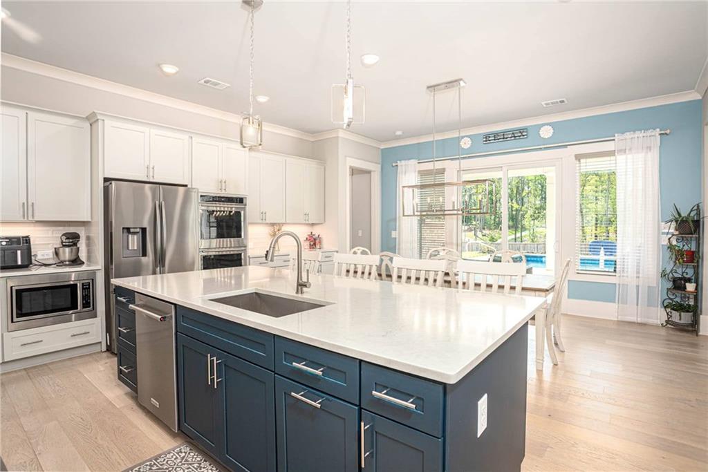 255 Old Town Road Dacula, GA 30019 - Photo 16 of 38 a kitchen with stainless steel appliances granite countertop a refrigerator a sink and a stove