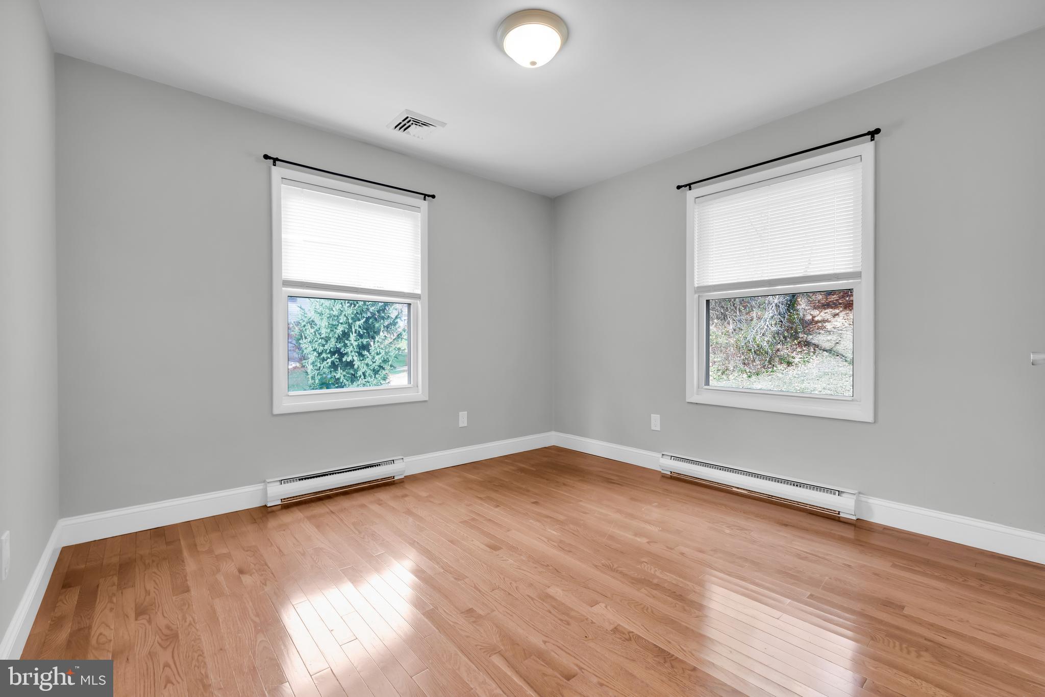 8979 Easton Road Ottsville, PA 18942 - Photo 17 of 39 an empty room with wooden floor and windows