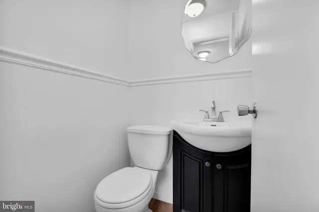 a bathroom with a sink toilet and a mirror