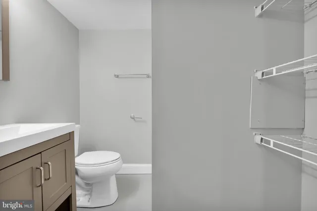 a white toilet sitting next to a bathroom sink