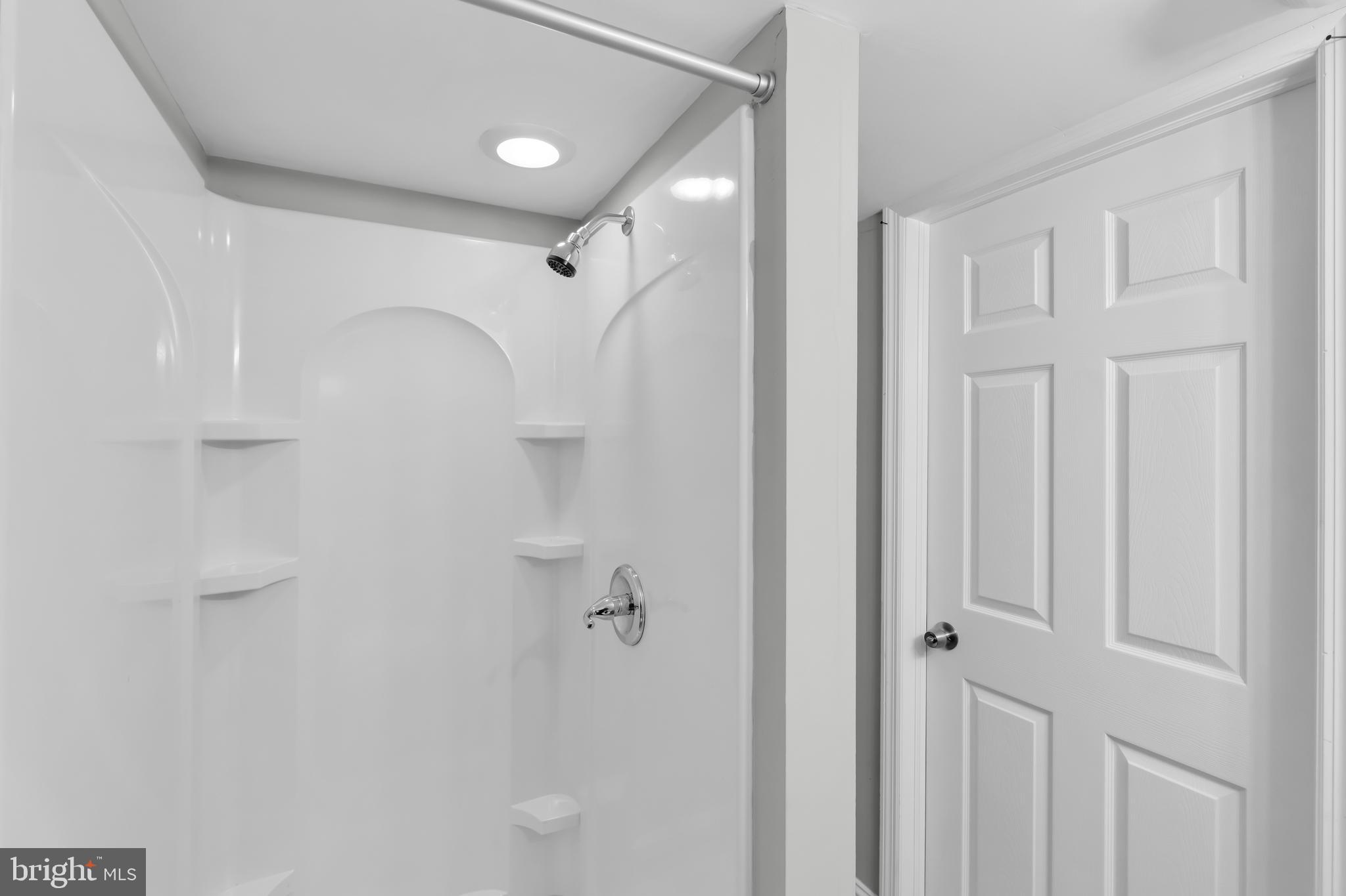 8979 Easton Road Ottsville, PA 18942 - Photo 28 of 39 a bathroom with a shower and a glass door