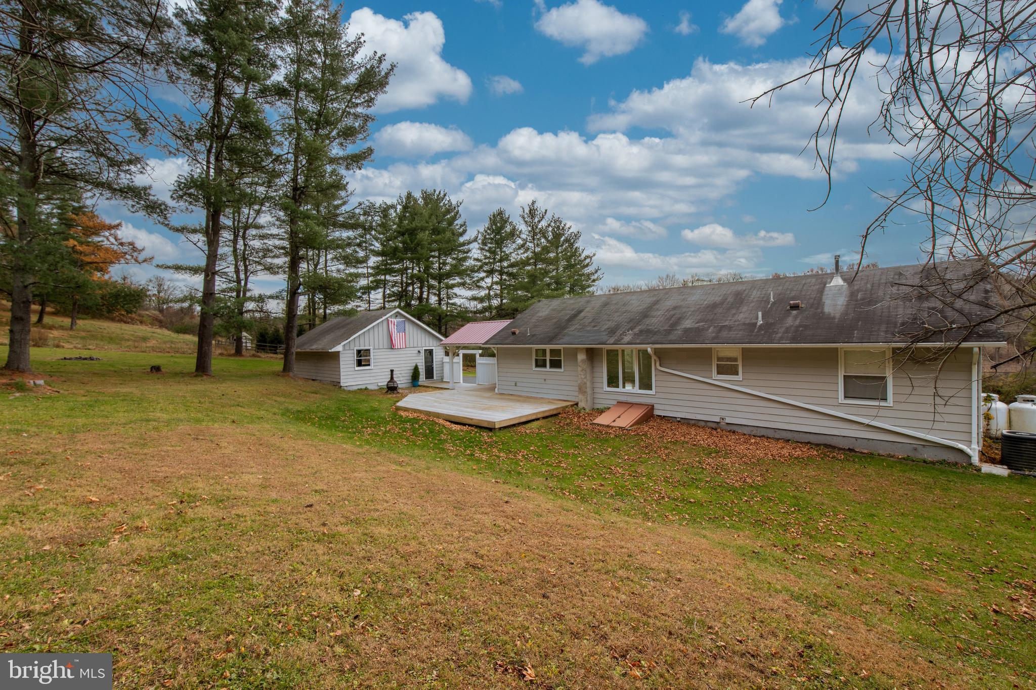 8979 Easton Road Ottsville, PA 18942 - Photo 33 of 39 a view of a house with a yard and a large tree
