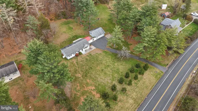 an aerial view of a house with a yard basket ball court