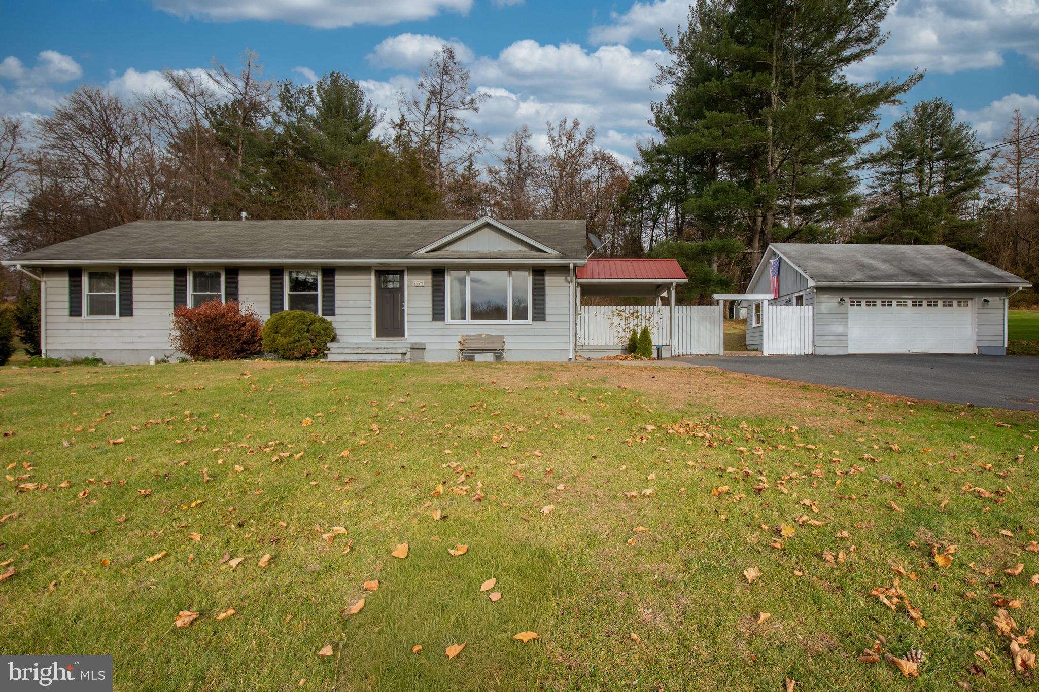 8979 Easton Road Ottsville, PA 18942 - Photo 5 of 39 a front view of a house with a garden and trees
