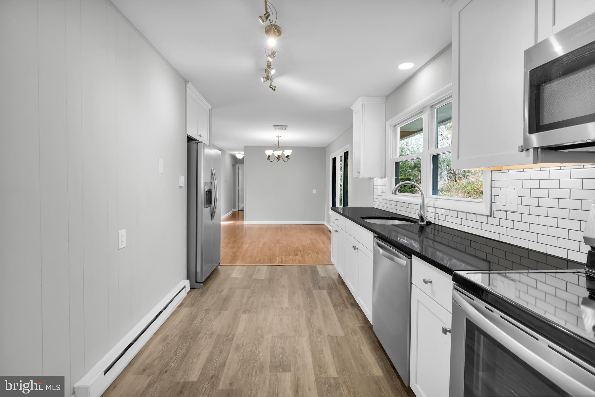 8979 Easton Road Ottsville, PA 18942 - Photo 9 of 39 a large kitchen with granite countertop a large counter top space a sink stainless steel appliances and cabinets