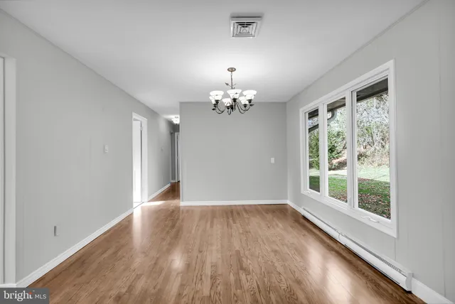 wooden floor in an empty room with a window