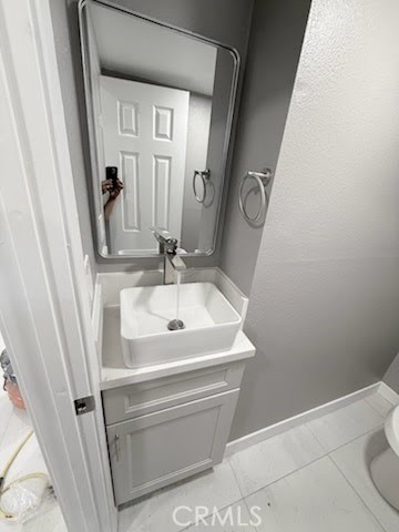 16586 Montego Way Tustin, CA 92780 - Photo 16 of 17 a bathroom with a sink a toilet and mirror