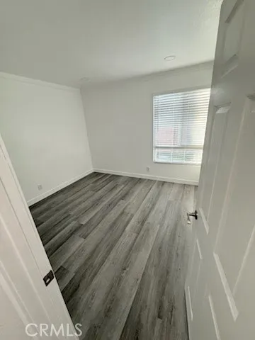 an empty room with wooden floor