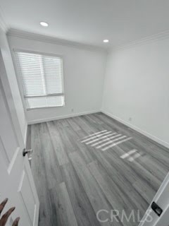 16586 Montego Way Tustin, CA 92780 - Photo 10 of 17 an empty room with wooden floor and windows