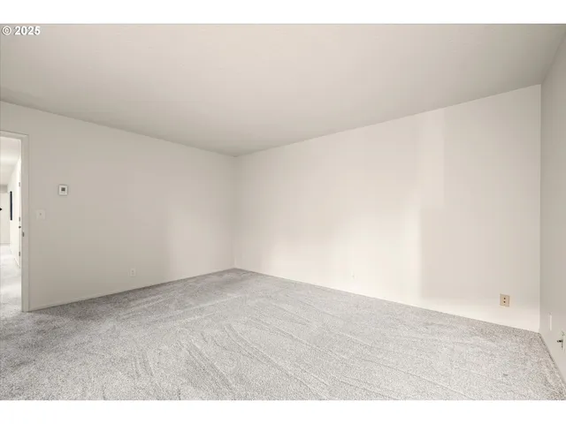 a big room with wooden floor and windows