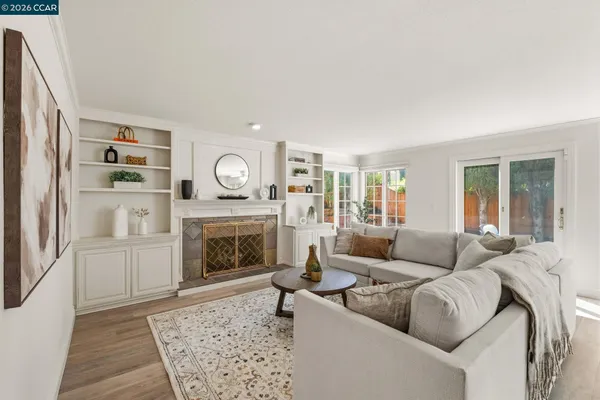 a living room with furniture and a fireplace