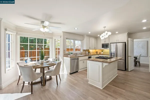 a kitchen with a stove a refrigerator and a sink