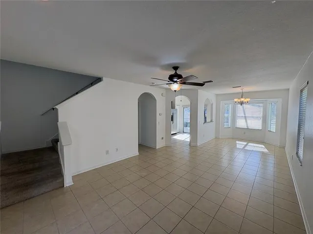 a view of a livingroom with a ceiling fan and window