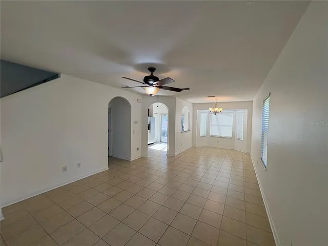 a view of a livingroom with a ceiling fan and window