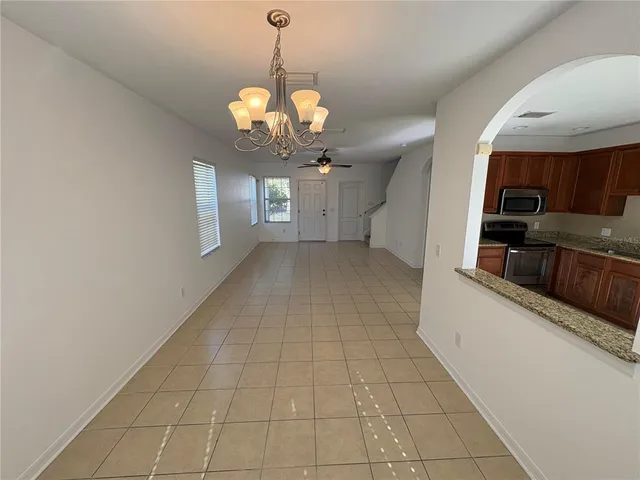 a view of a kitchen with a sink and chandelier