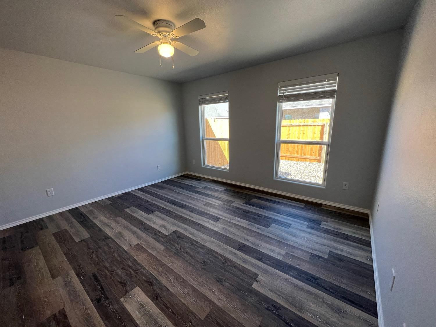 5611 Jarvis Street, Unit B Lubbock, TX 79416 - Photo 9 of 20 a view of empty room with wooden floor and fan