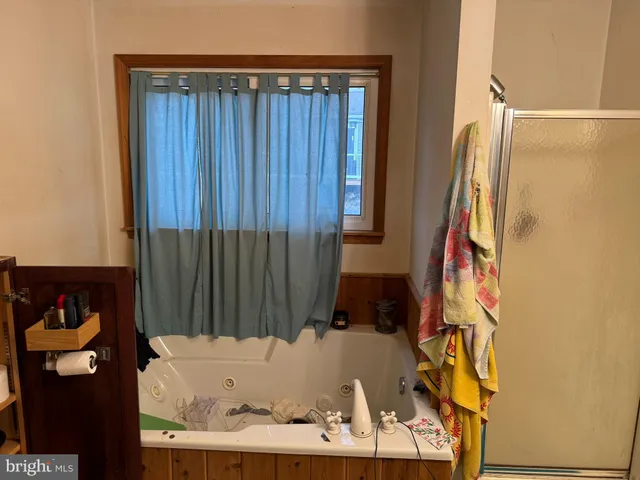 a bathroom with a bathtub and shower