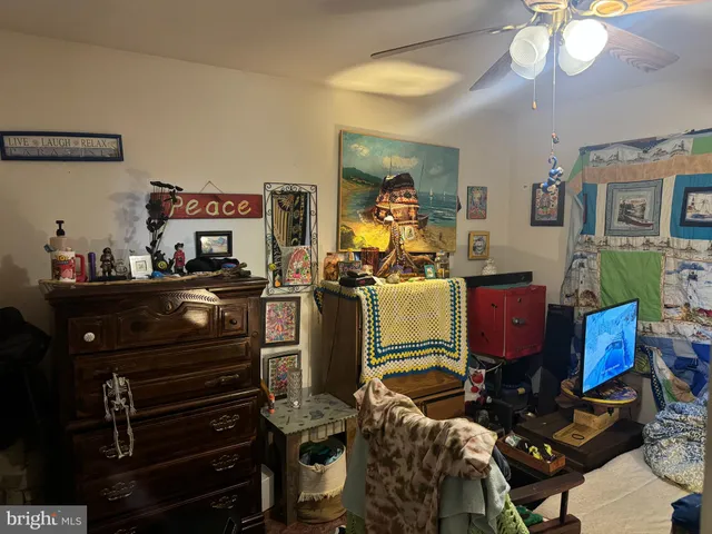 a room with furniture a flat screen tv and a mirror