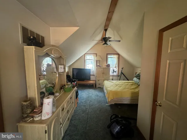 a living room with furniture and a mirror