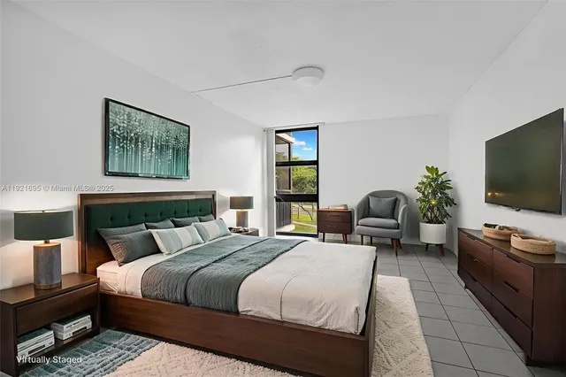 a bedroom with a bed and a flat screen television