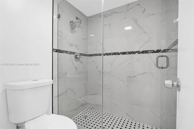 a bathroom with a shower and a toilet