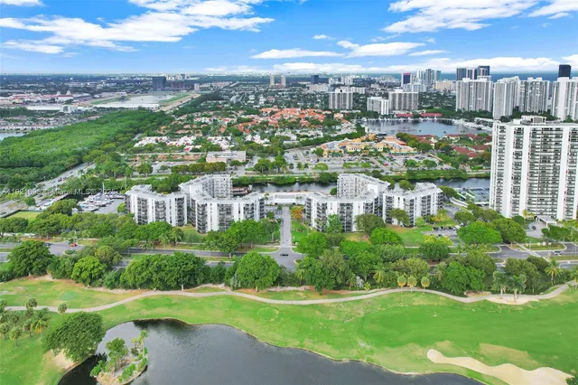 a view of a yard with plants and a building