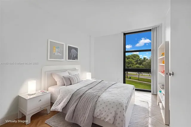 a bedroom with a bed and a large window