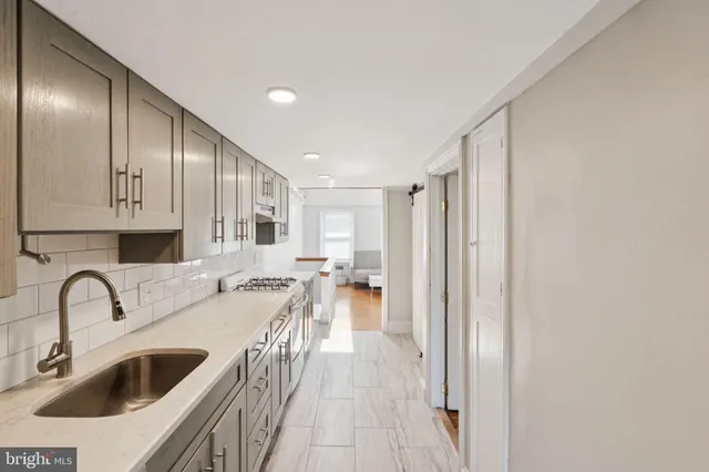 a view of a kitchen with a sink and cabinets