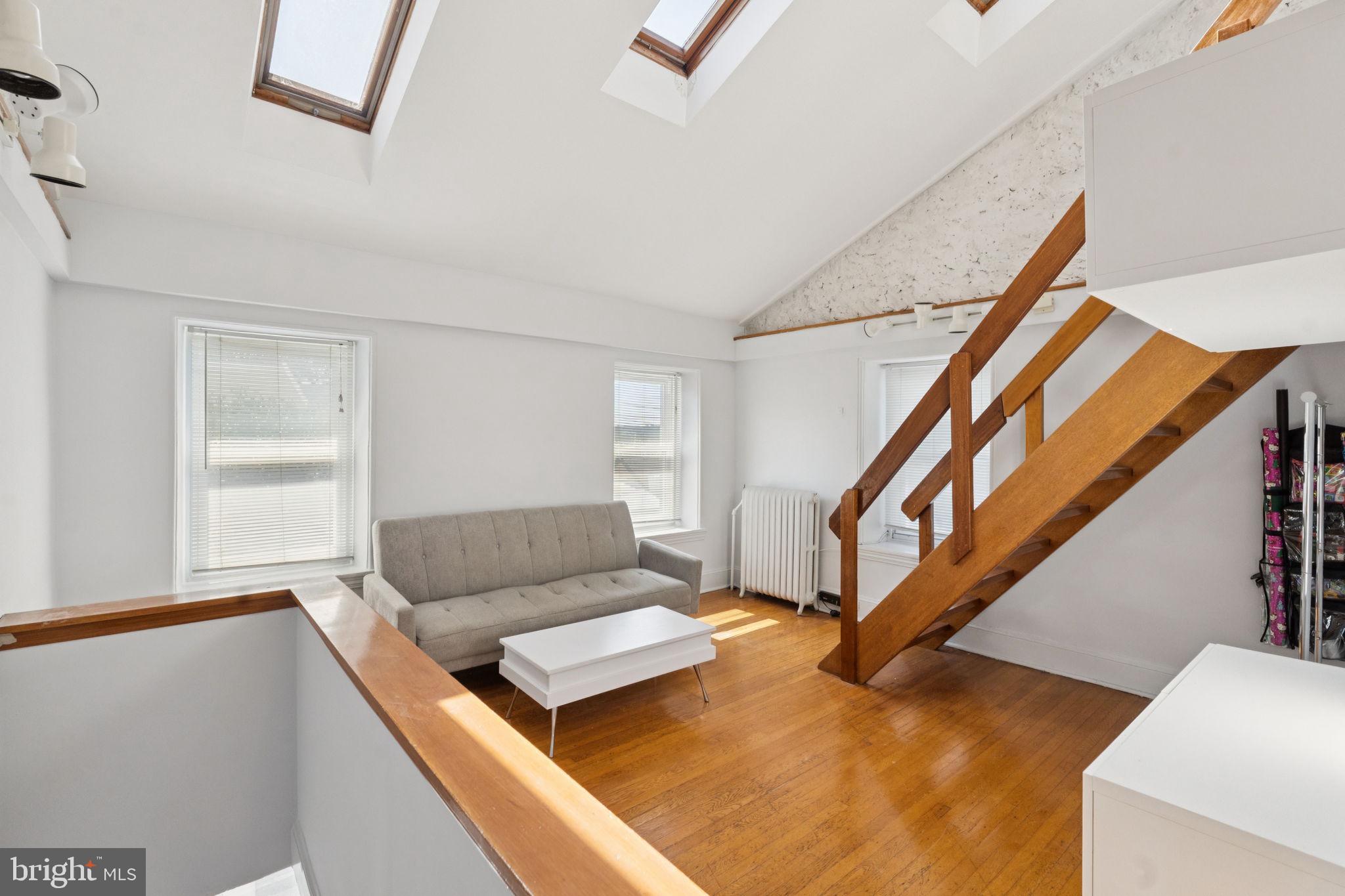 3715 Calumet Street, Unit 3 Philadelphia, PA 19129 - Photo 2 of 19 a living room with furniture and stairs