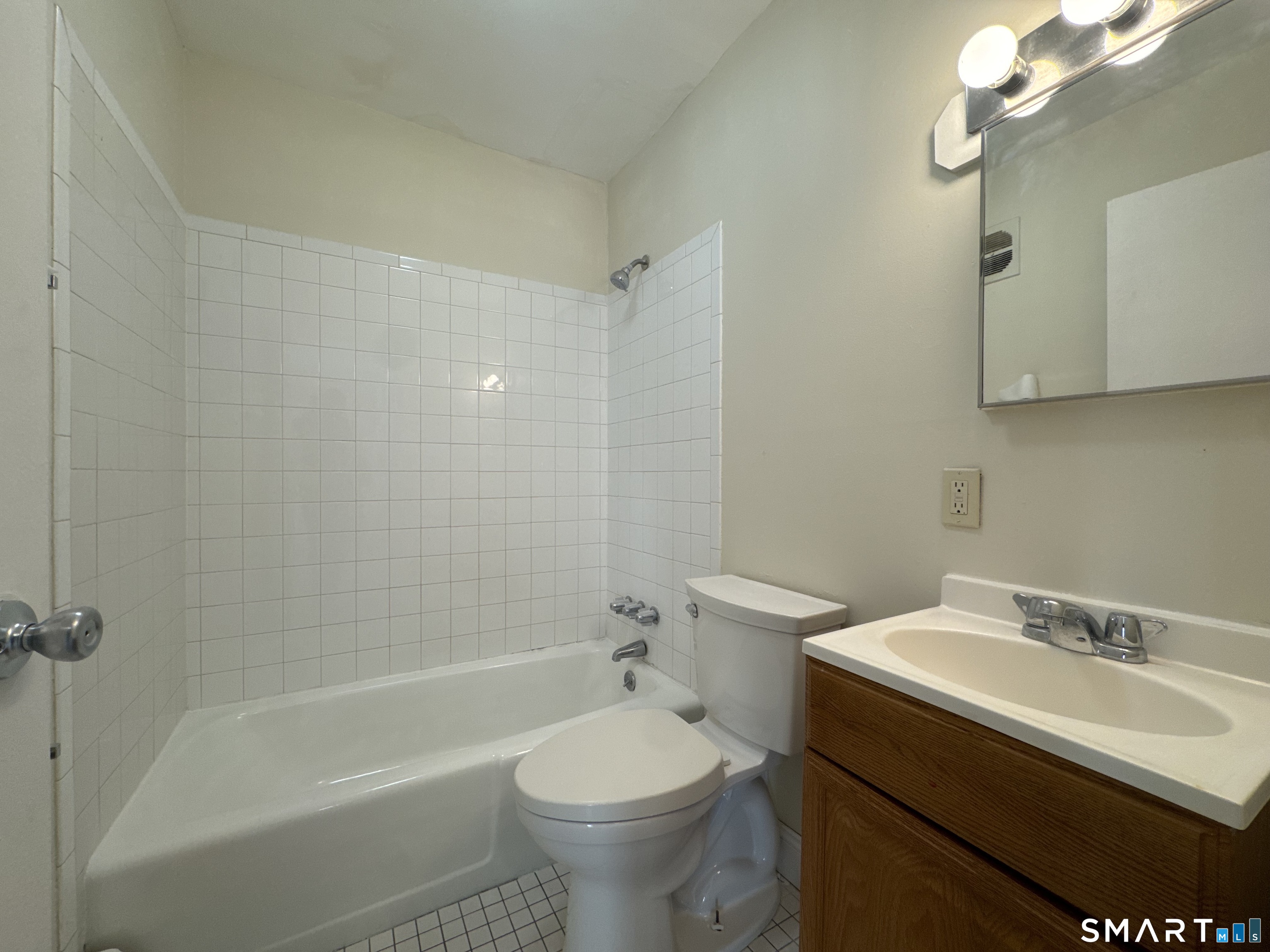 145 Cowles Street, Unit B3 Bridgeport, CT 06607 - Photo 6 of 8 a bathroom with a sink a toilet and shower