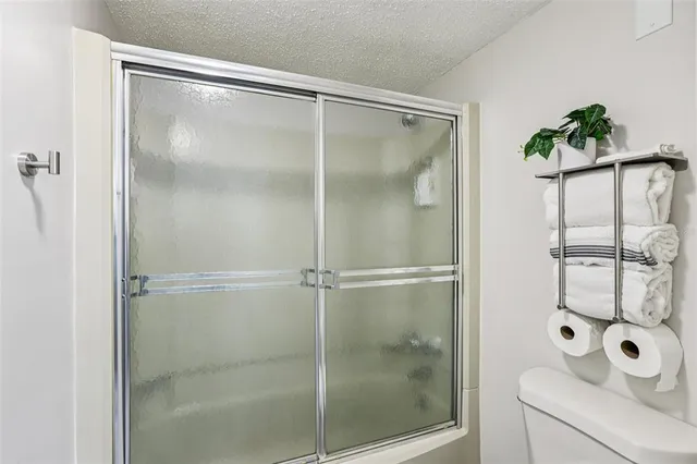 a bathroom with a glass shower door