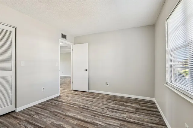 a view of a room with wooden floor and windows