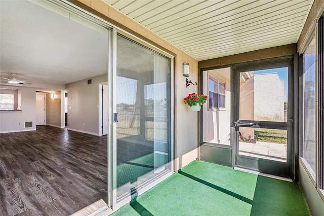 a porch with seating space and hardwood floor