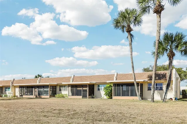 a front view of a residential apartment building with a yard