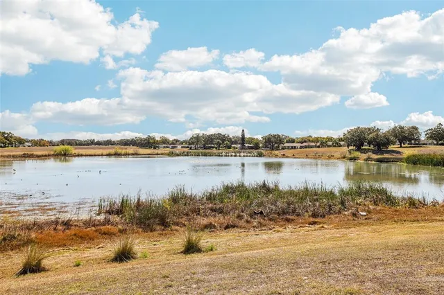 a view of a lake with houses in the background