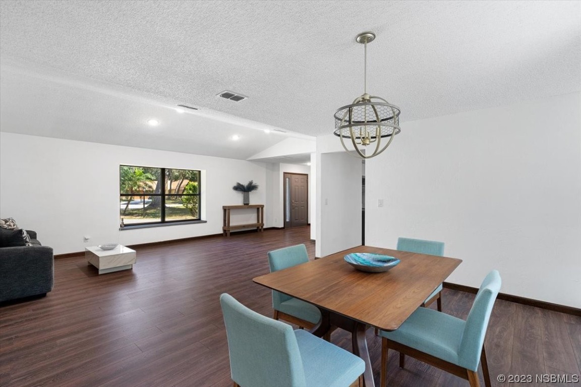 6202 Yellowstone Drive Port Orange, FL 32127 - Photo 13 of 34 a view of a dining room with furniture wooden floor and chandelier