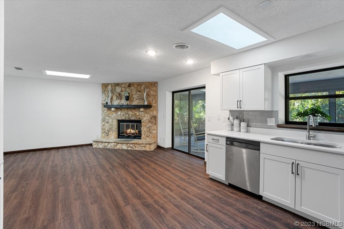 6202 Yellowstone Drive Port Orange, FL 32127 - Photo 15 of 34 a view of a kitchen with a sink dishwasher and a fireplace
